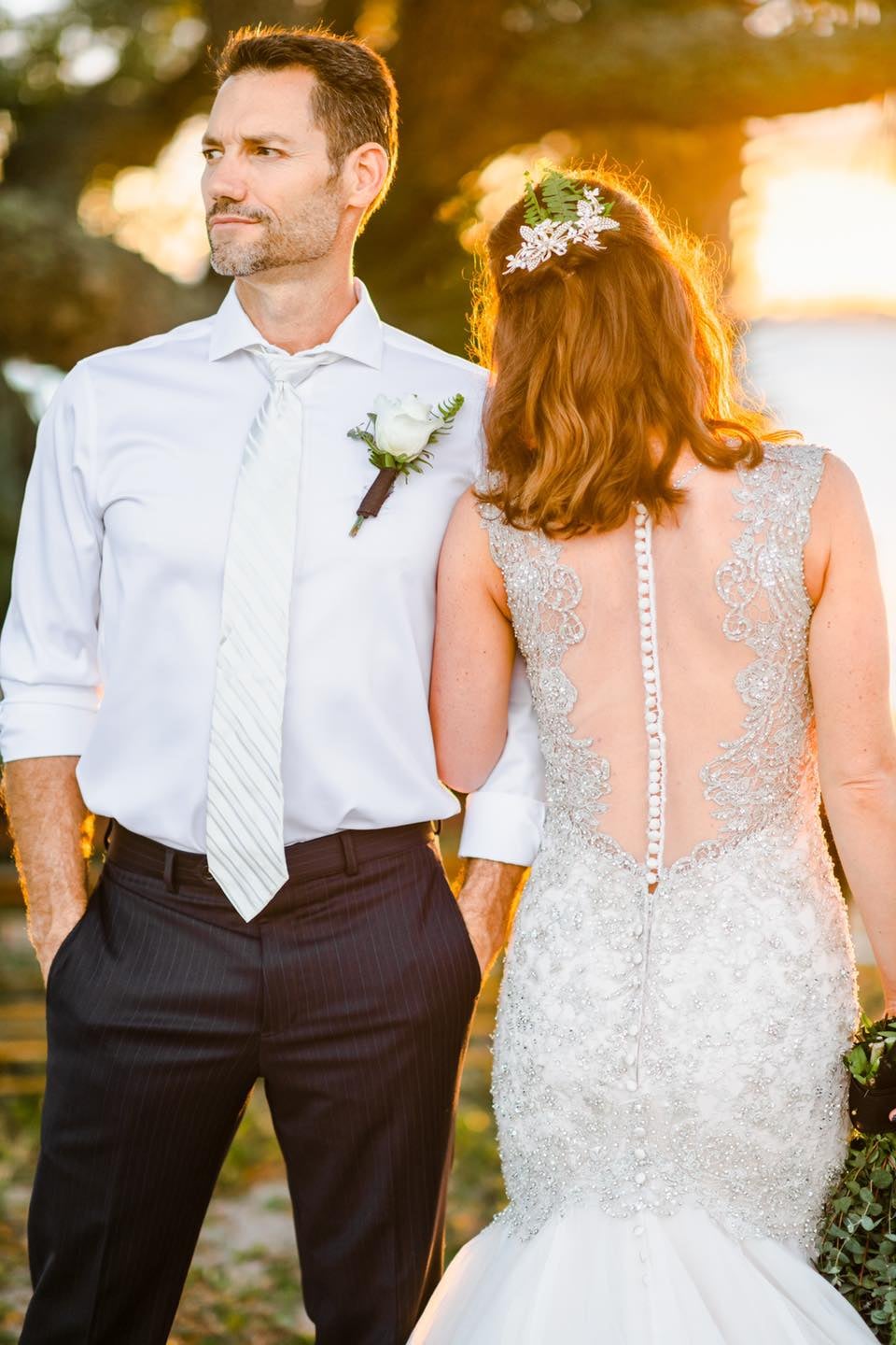 bride embracing groom at golden hour