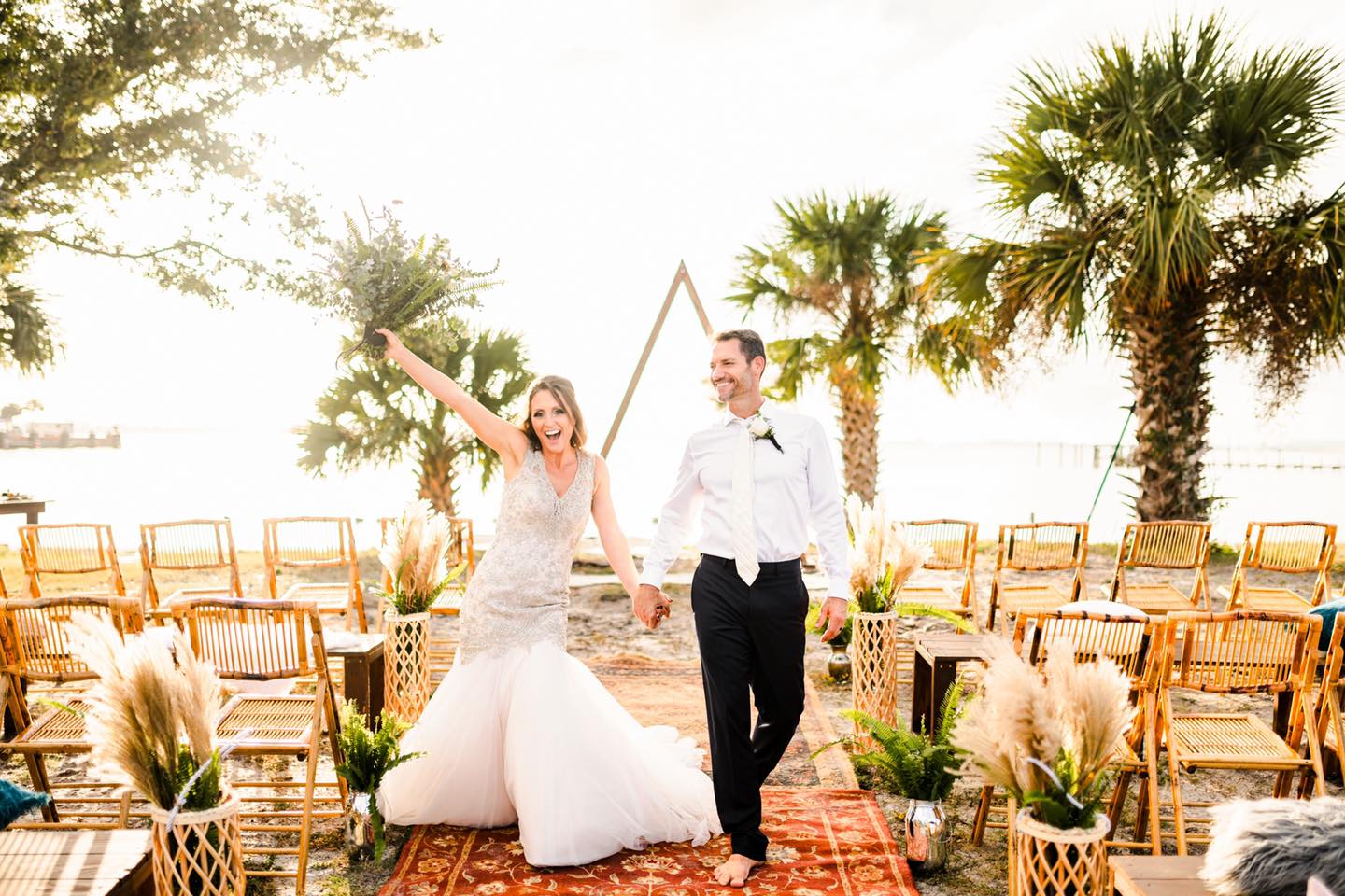 bride and groom cheering walking down aisle