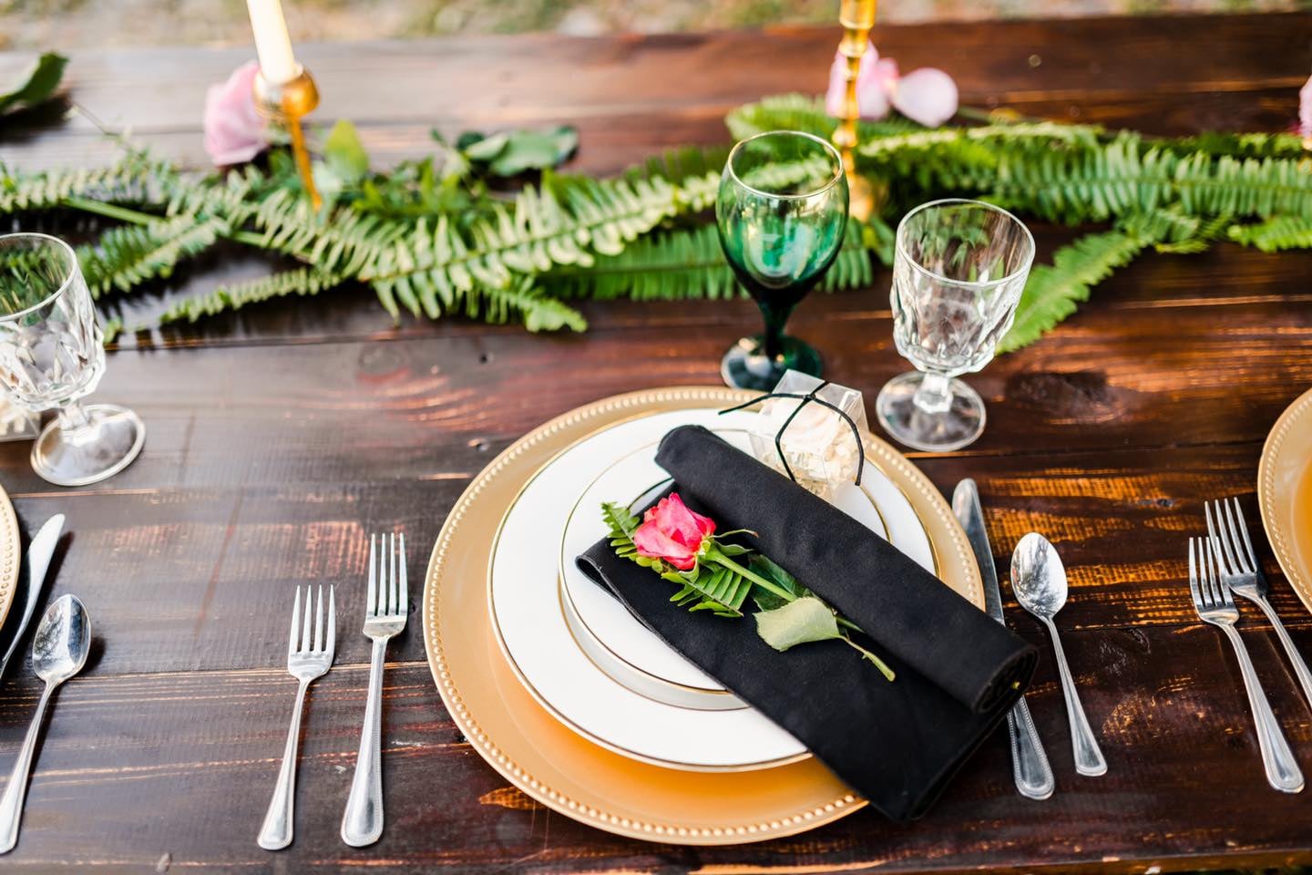 black and gold table setting for wedding reception